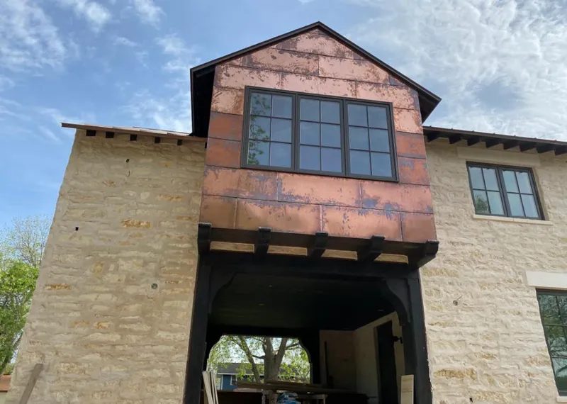 Copper metal panel facade on a stone building for Roof Repair in Gustine