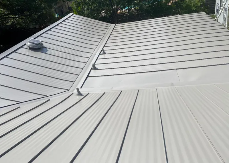 Solar attic fan installed on a metal roof for Roof Ventilation in Gustine